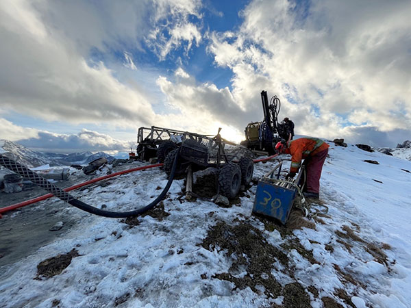 Photo 1: View of workers setting up RC Rig in preparation for drilling at ERT Zone on Pike Warden Property